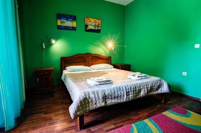 a green bedroom with a bed and a green wall at Villa Elkom App 2 in Ulcinj