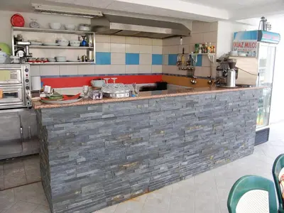 a kitchen with a brick counter in a kitchen at Villa Elkom, App. 8 in Ulcinj