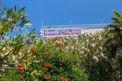 a sign for the rooms atlantis sign behind trees at Villa Elkom, App.11 in Donji Štoj