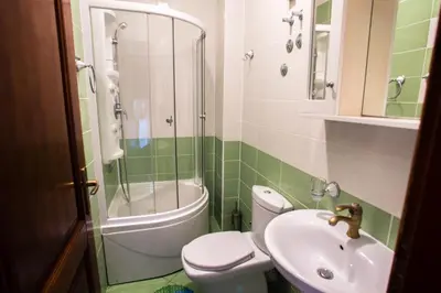 a bathroom with a toilet and a sink and a shower at Villa Elkom, App.9 in Ulcinj