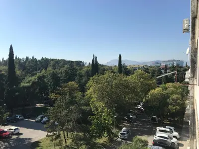 a view of a parking lot with cars parked at SunFlat Podgorica - Novakovic Residence in Podgorica