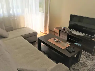 a living room with a couch and a coffee table at SunFlat Podgorica - Novakovic Residence in Podgorica