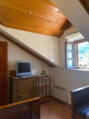 a living room with a tv on a dresser at Apartments Vujošević in Kotor