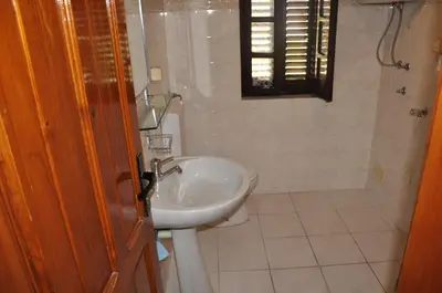 a bathroom with a sink and a toilet at Apartments Vujošević in Kotor