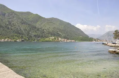 a body of water with mountains in the background at Apartments Vujošević in Kotor