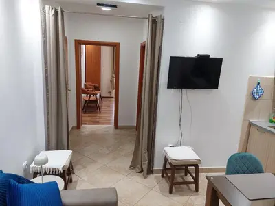 a living room with a tv on a wall at Apartments Nancy in Kotor