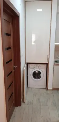 a washer and dryer in a room with a door at Apartments Nancy in Kotor
