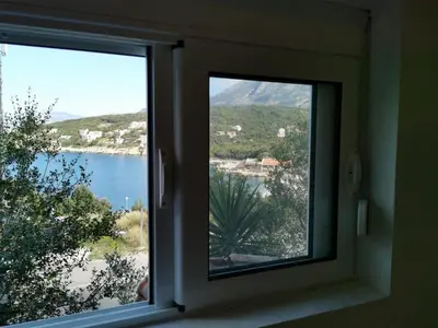 a window with a view of a body of water at STUDIO Carpe Diem in Utjeha