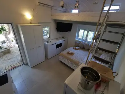 a small room with a bed and a ladder in it at STUDIO Carpe Diem in Utjeha