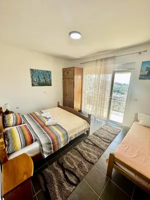 a bedroom with a large bed and a window at Sea View Apartment Ulcinj 80 m² in Ulcinj