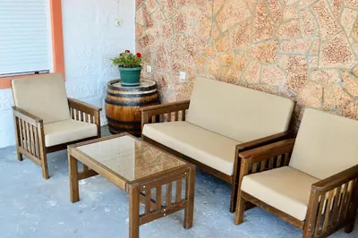 three chairs and a coffee table in front of a wall at Sea View Apartment Ulcinj 80 m² in Ulcinj