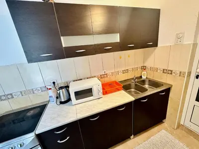 a small kitchen with a sink and a microwave at Sea View Apartment Ulcinj 80 m² in Ulcinj