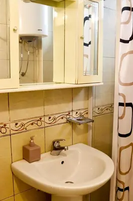 a white sink in a bathroom with a mirror at Sea View Apartment Ulcinj 80 m² in Ulcinj