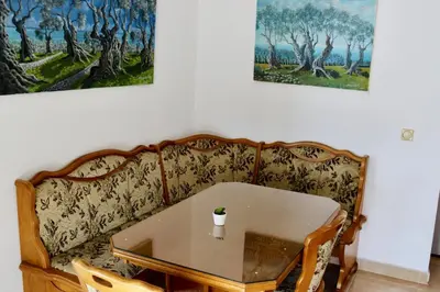 a living room with a table and a couch at Sea View Apartment Ulcinj 80 m² in Ulcinj