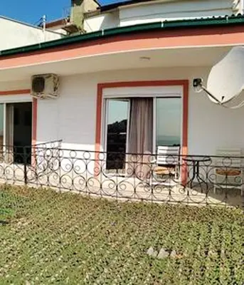 a house with a balcony with a view of the ocean at Comfortable Apartment in Ulcinj with Sea View and Garden in Ulcinj