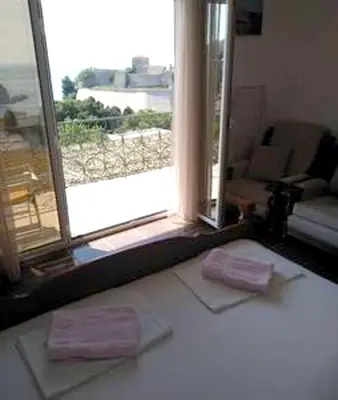 a living room with a window and two pink towels at Comfortable Apartment in Ulcinj with Sea View and Garden in Ulcinj