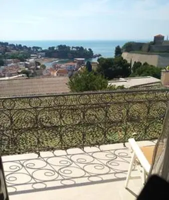 a balcony with a chair and a view of the ocean at Comfortable Apartment in Ulcinj with Sea View and Garden in Ulcinj