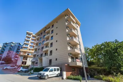 a white van parked in front of a tall building at Apartment with bedroom Becici White in Becici