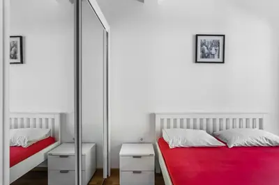 a bedroom with two beds and a mirror at Apartment with bedroom Becici White in Becici