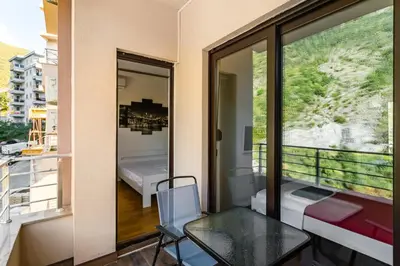 a room with a glass table and a balcony at Apartment with bedroom Becici White in Becici