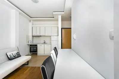 a living room with a couch and a kitchen at Apartment with bedroom Becici White in Becici