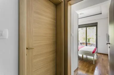 a wooden door in a room with a bedroom at Apartment with bedroom Becici White in Becici