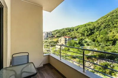 a balcony with a chair and a view of a mountain at Apartment with bedroom Becici White in Becici