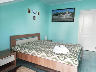 a bedroom with a bed and a blue wall at Apartment Azalea of Budva in Budva