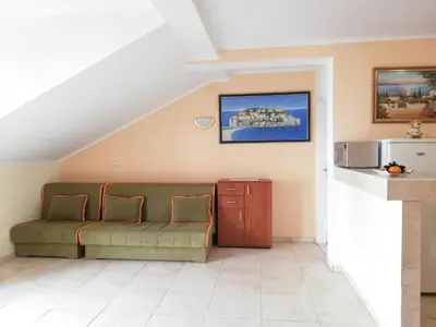 a living room with a couch and a table at Apartment Azalea of Budva in Budva