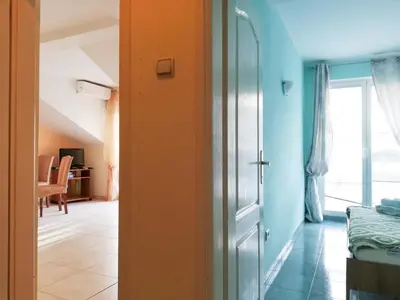 a room with an orange door and a bedroom at Apartment Azalea of Budva in Budva