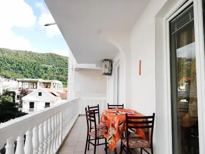 a white balcony with a table and chairs at Apartment Azalea of Budva in Budva