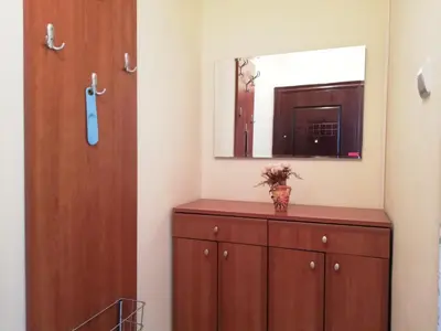 a bathroom with a wooden cabinet and a mirror at Apartment Azalea of Budva in Budva