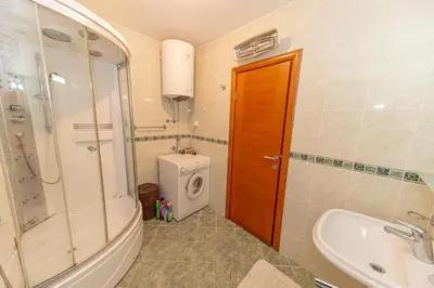 a bathroom with a sink and a toilet and a shower at Apartment Qservice Petrovac in Budva