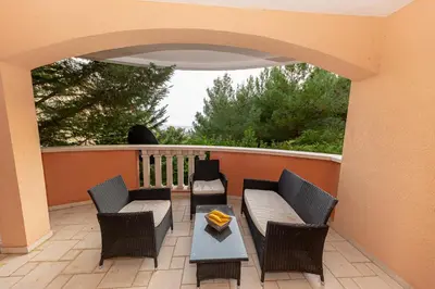a patio with chairs and a table on a balcony at Apartment Qservice Petrovac in Budva