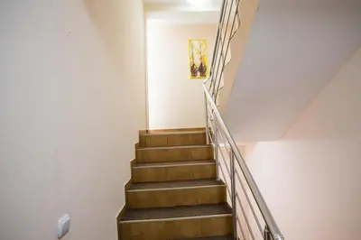 a staircase in a house with wooden steps at Villa Elkom, App 14 in Ulcinj