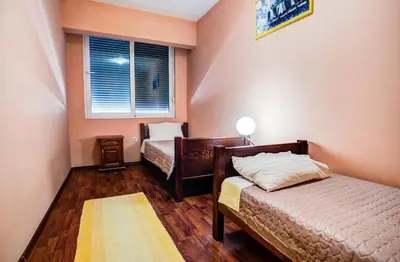 a bedroom with two beds and a window at Villa Elkom, App 14 in Ulcinj