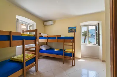 a room with bunk beds in a house at Montenegro Hostel 4U in Kotor