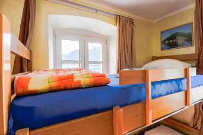 a bedroom with two bunk beds and a window at Montenegro Hostel 4U in Kotor