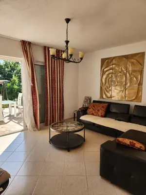 a living room with a couch and a glass table at Villa Alisa in Dobra Voda