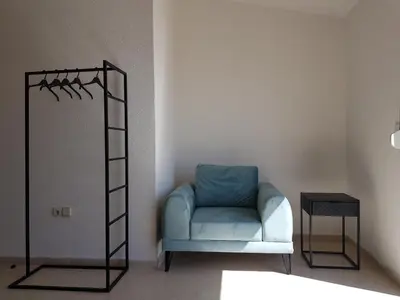 a room with a blue chair and a ladder at Villa Alisa in Dobra Voda