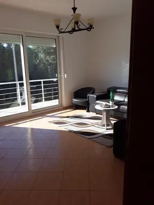 a living room with a couch and a table at Villa Alisa in Dobra Voda