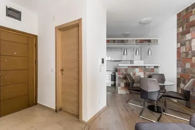 a living room with a table and chairs at Apartments BEATRICE Rafailovici in Rafailovici