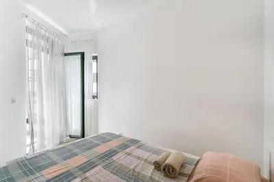 a bedroom with a bed with two towels on it at Apartments BEATRICE Rafailovici in Rafailovici