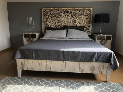 a bedroom with a bed and two night stands at Апартаменты Anturage с отдельным входом in Dobra Voda