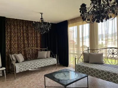 a living room with a couch and a glass table at Апартаменты Anturage с отдельным входом in Dobra Voda
