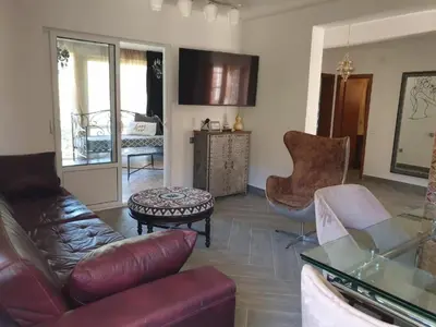 a living room with a couch and a table at Апартаменты Anturage с отдельным входом in Dobra Voda