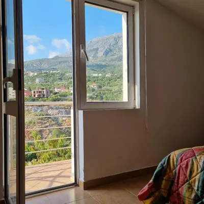 a room with a window with a view of a mountain at Апартаменты Anturage с отдельным входом in Dobra Voda