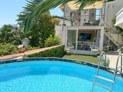 a swimming pool in the backyard of a house at Apartmani Avanti Becici in Becici