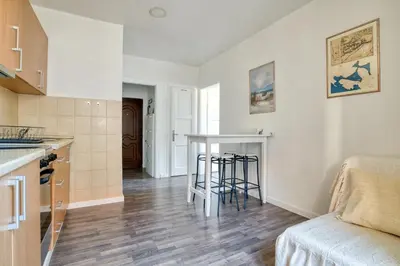 a kitchen and living room with a table in a room at Bright, Romantic & Super Stylish Old Town Flat with Seaview & Shared Terrace in Kotor