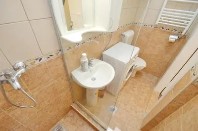 a bathroom with a toilet and a sink and a shower at Bright, Romantic & Super Stylish Old Town Flat with Seaview & Shared Terrace in Kotor